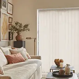 cream vertical blinds and white sofa